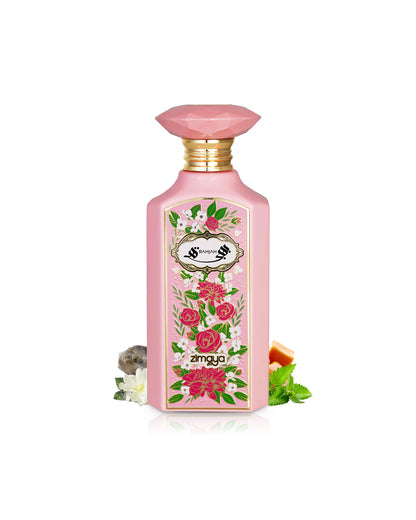 zimaya bahja perfume bottle surrounded with its ingredients like musk and patchouli shows from behind the bottle against white background